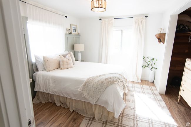 Bedroom with light wood-type flooring | Image 13