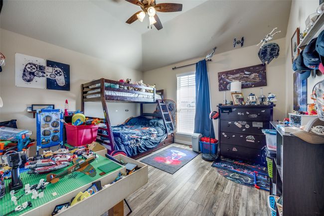 Bedroom with hardwood / wood-style flooring, vaulted ceiling, and ceiling fan | Image 17