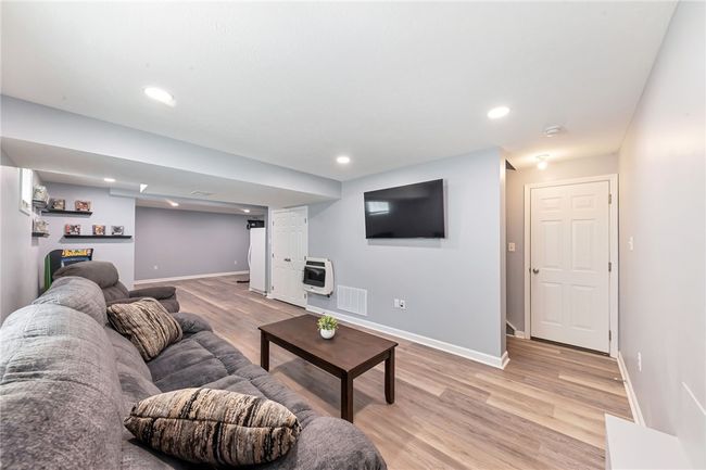 There is plumbing for a bathroom roughed in behind the refrigerator. View of the man door leading to the extra deep 2 car garage. | Image 35