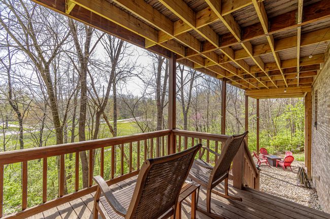 wooden terrace featuring a view of trees | Image 43