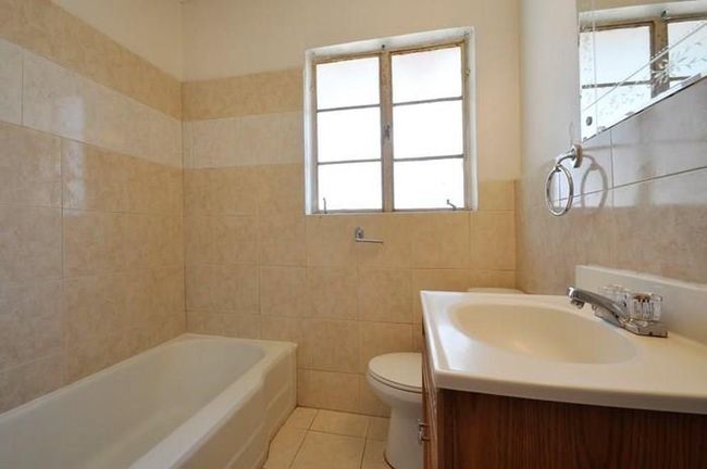Bathroom featuring a tub to relax in, tile walls, vanity, and tile patterned floors | Image 13
