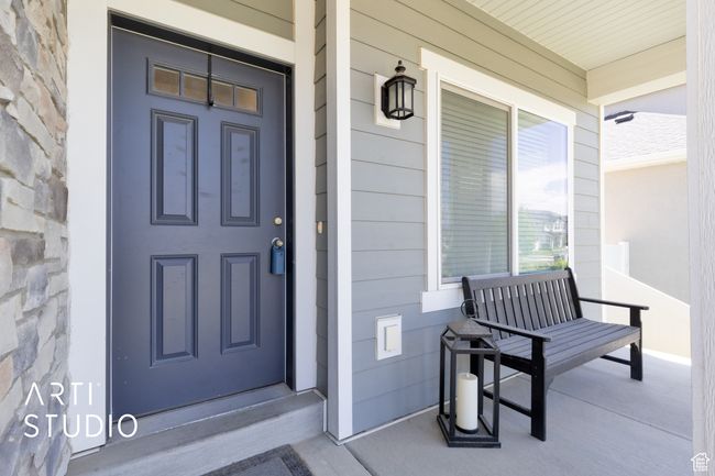 Doorway to property featuring a porch | Image 4