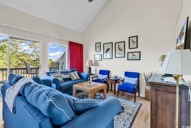 Living area with baseboards, light wood-style flooring, and high vaulted ceiling | Image 16