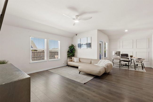 Living room with ceiling fan, lofted ceiling, wood finished floors, and baseboards | Image 8