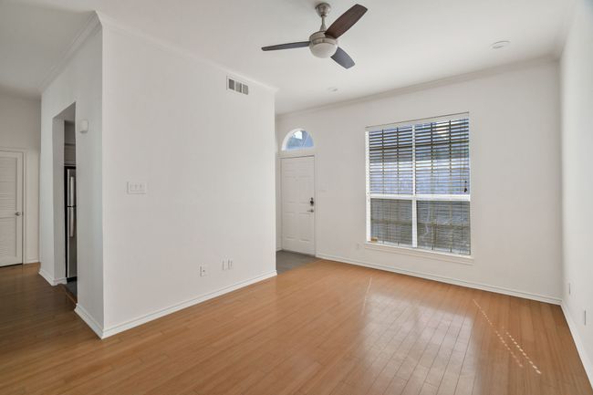 Spare room with wood finished floors, visible vents, and crown molding | Image 6