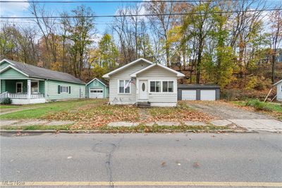 View of front of property featuring an outbuilding, a garage, and covered porch | Image 2