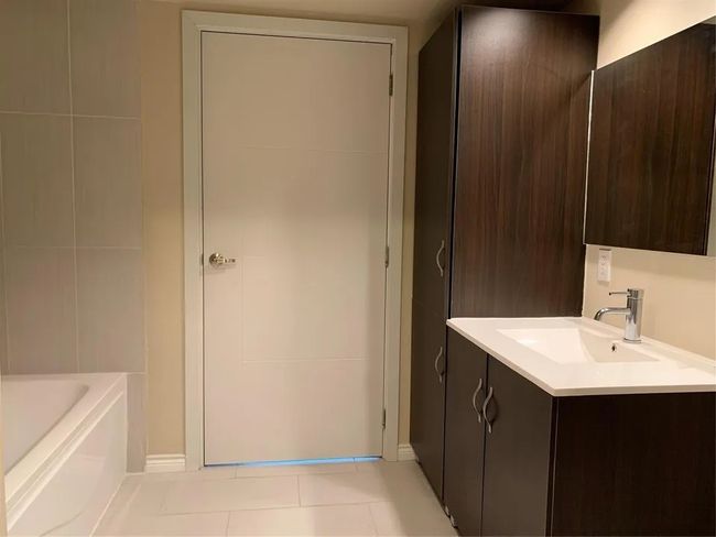 Full bath featuring vanity, tile patterned flooring, and a tub | Image 22