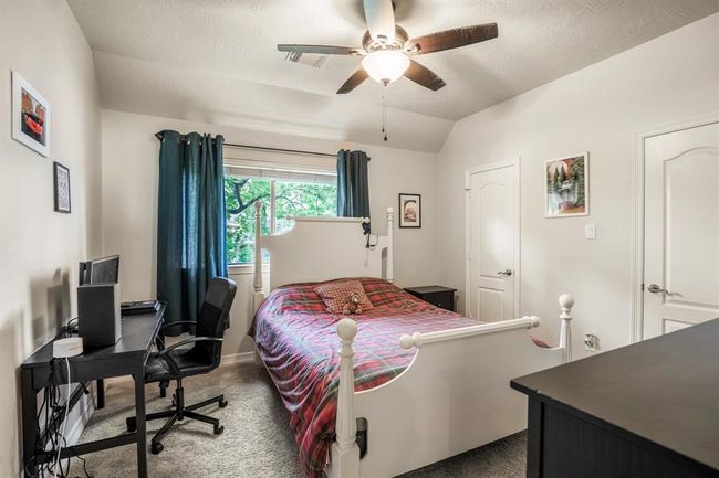 All the bedrooms offer spacious rooms. This is the second bedroom that is located upstairs, with lots of windows that allow for natural lighting. | Image 31