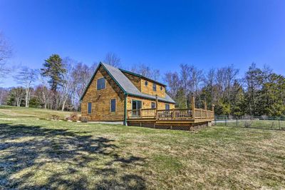 Back of house featuring a wooden deck and a lawn | Image 2