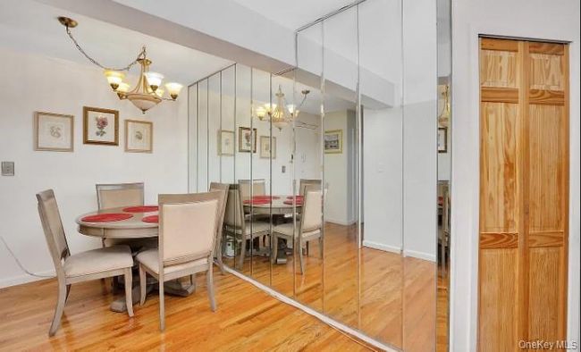 Dining room featuring a chandelier and wood finished floors | Image 8