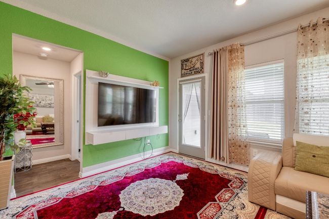 Living area featuring vinyl wood floors and baseboards | Image 7
