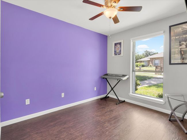 Empty room with dark wood-type flooring, plenty of natural light, and a ceiling fan | Image 22