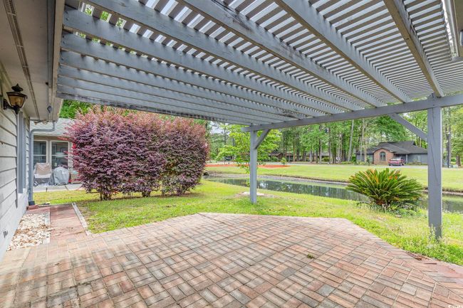 View of patio / terrace with a pergola and a water view | Image 28