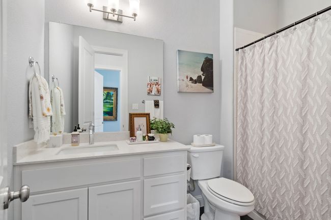 Bathroom with vanity and curtained shower | Image 19