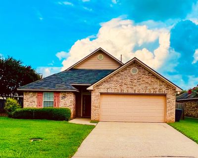 View of front facade featuring a garage and a front yard | Image 1