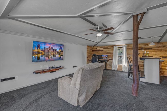 Expansive family room with bookshelves galore. | Image 11