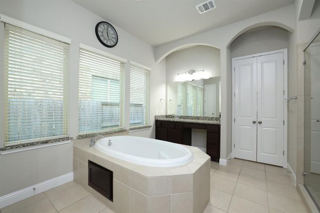 Soaking tub and granite windowsills. One vanity with makeup station and drawer | Image 32