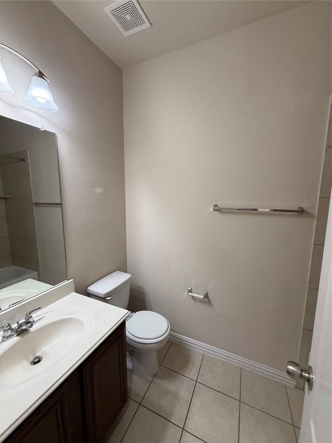 Bathroom featuring vanity, visible vents, toilet, tile patterned floors, and baseboards | Image 20