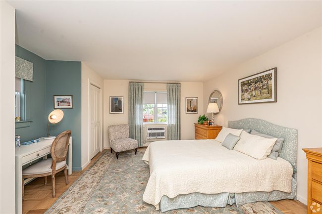 Bedroom featuring baseboards and a wall mounted AC | Image 5