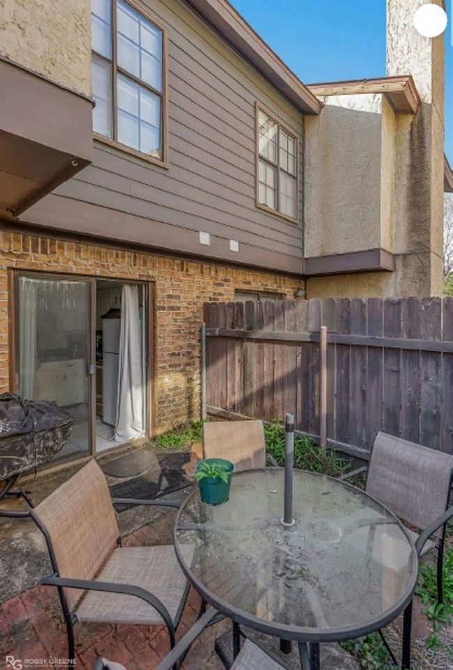 View of patio featuring fence and outdoor dining space | Image 4