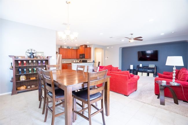 Dining area featuring a chandelier, a ceiling fan, and recessed lighting | Image 8
