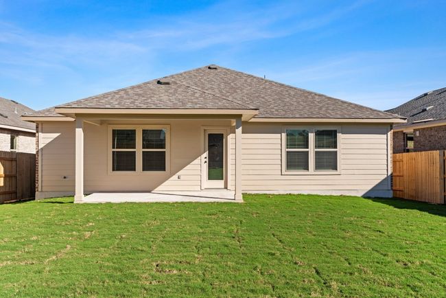 Rear view of property featuring roof with shingles, a patio area, fence, and a lawn | Image 28