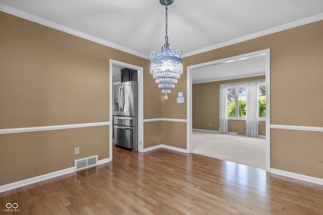 Dining room features beautiful hardwood floors | Image 9