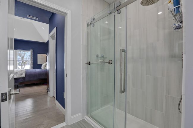 Bathroom with hardwood / wood-style flooring and walk in shower | Image 17
