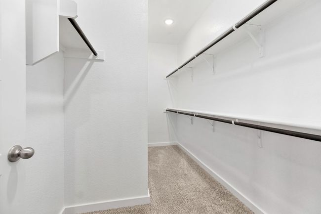 Spacious closet with light carpet | Image 24