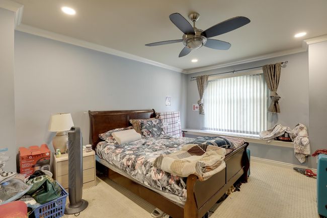 Carpeted bedroom featuring recessed lighting, ornamental molding, a ceiling fan, and baseboards | Image 21