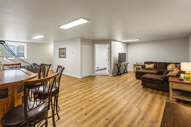 Living area with light wood finished floors and baseboards | Image 35