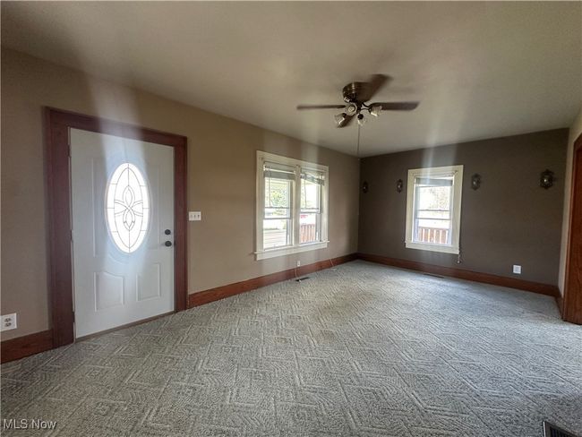Entrance foyer featuring carpet, a ceiling fan, and a wealth of natural light | Image 6