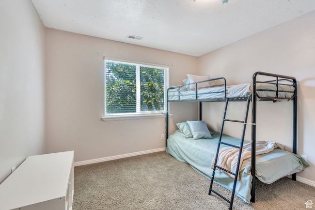 Bedroom with carpet flooring and baseboards | Image 10