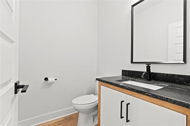 Half bathroom featuring wood finished floors and vanity | Image 17