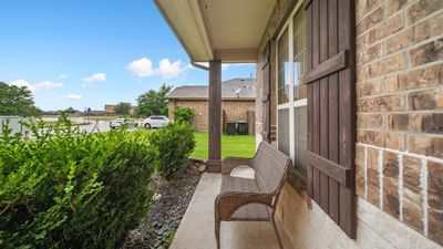 This home features impeccable curb appeal with a beautiful brick and stone exterior elevation. Great front porch to sit back and relax. | Image 2