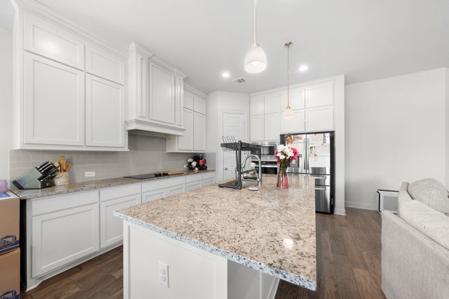 Kitchen with appliances with stainless steel finishes, recessed lighting, backsplash, and dark wood-type flooring | Image 11