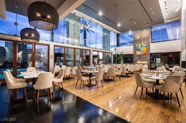 Dining space featuring a towering ceiling | Image 10