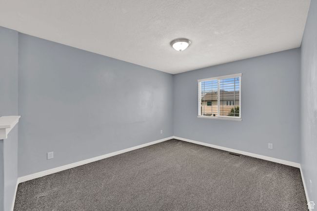 Empty room with carpet and a textured ceiling | Image 18