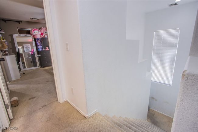 Hallway featuring light carpet and baseboards | Image 14