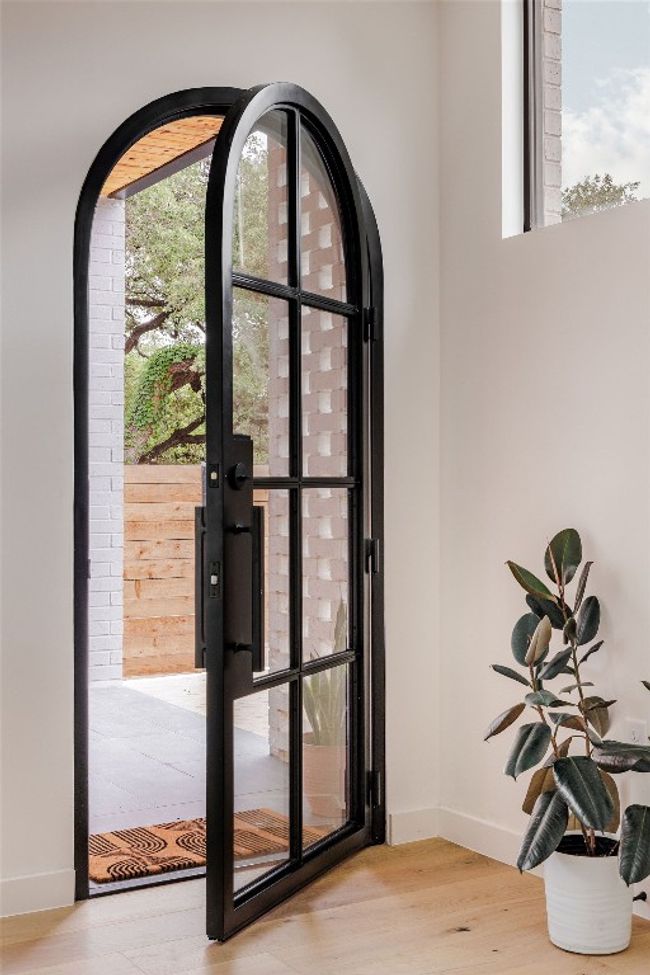 Entryway with wood finished floors, baseboards, and arched walkways | Image 5