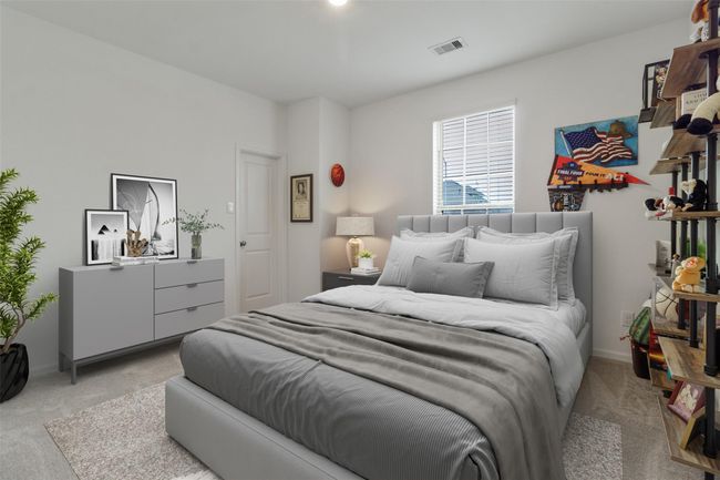 This virtually staged bedroom is just off the entry way. | Image 4