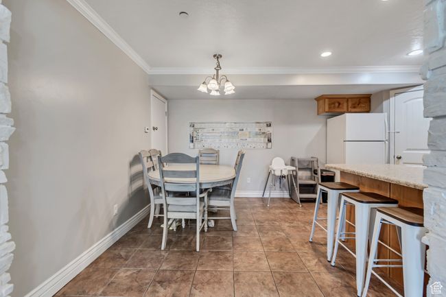 Dining room with ornamental molding, a chandelier, and recessed lighting | Image 10