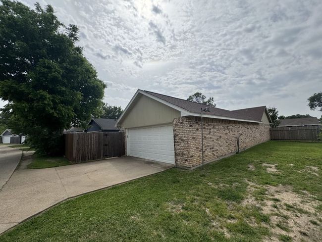 View of home's exterior featuring a garage and a lawn | Image 30