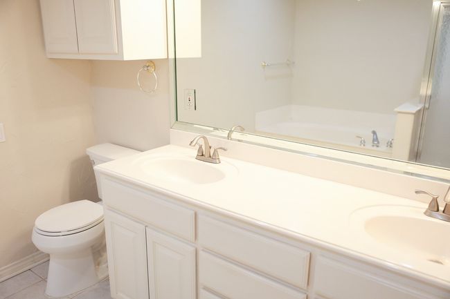 Bathroom with double vanity, a bath, and tile patterned floors | Image 37