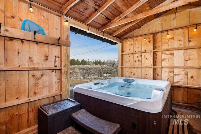 Miscellaneous room featuring wooden ceiling, a hot tub, and wooden walls | Image 24
