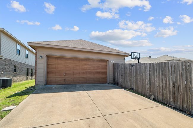 Detached garage featuring central AC unit and fence | Image 38