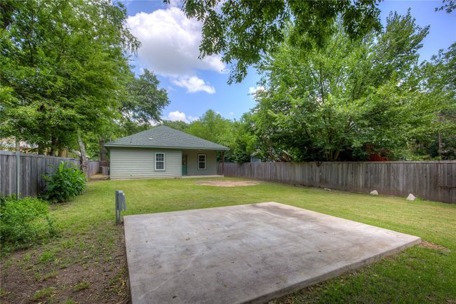 Fenced backyard with a patio area | Image 32