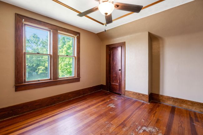 Unfurnished room featuring hardwood / wood-style floors and a ceiling fan | Image 26