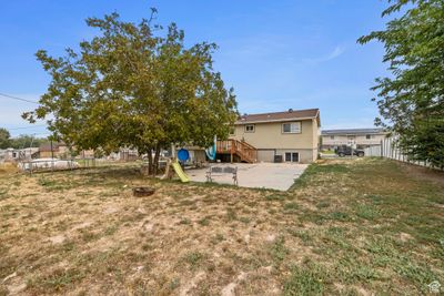 View of yard with a playground and a patio | Image 3