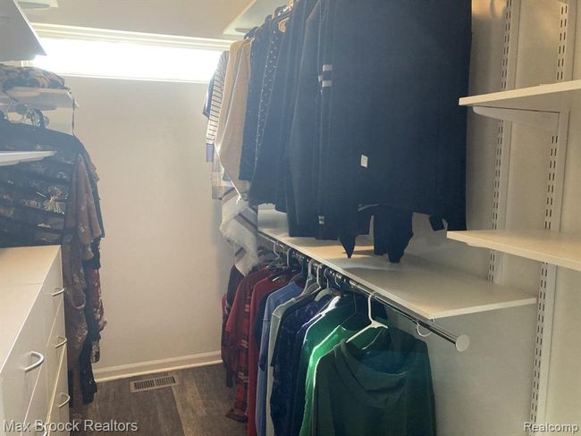 Primary walk-in closet with organizers. | Image 15